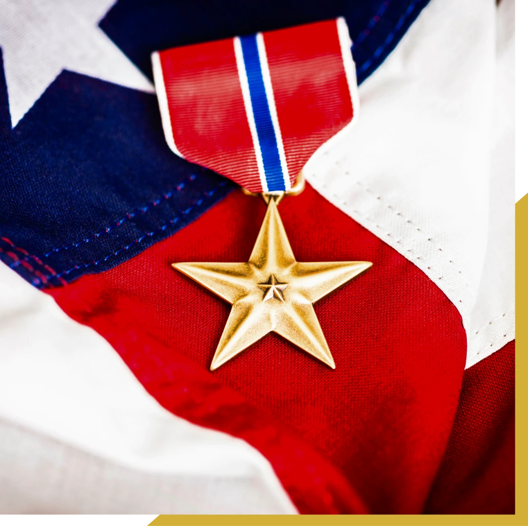 Gold star medal on American flag.